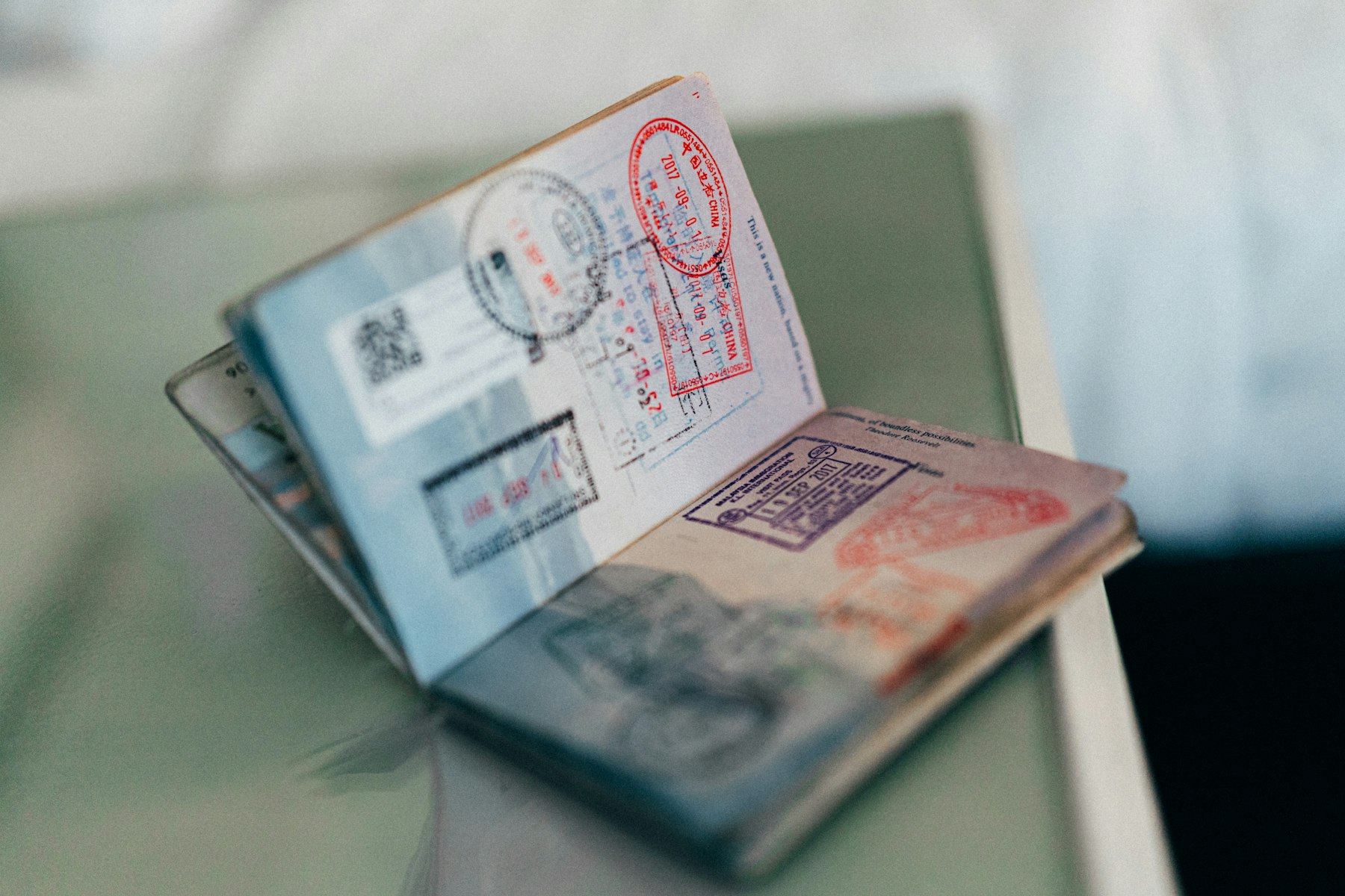 Aufgeschlagener Reisepass mit Einreisestempeln auf einer hellen Fläche